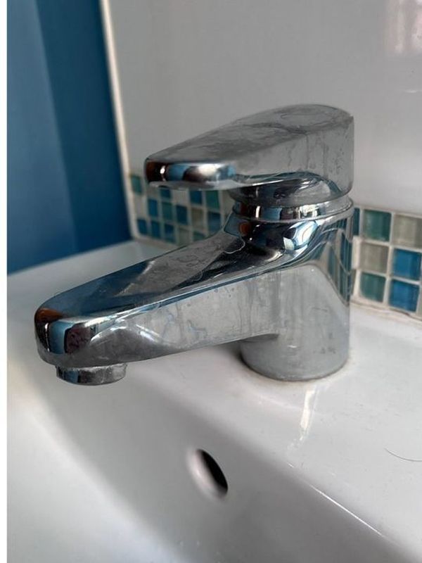 Before: the basin mixer tap dull and marked