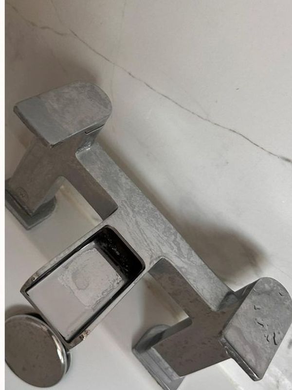 Before: the bathroom mixer taps covered in limescale