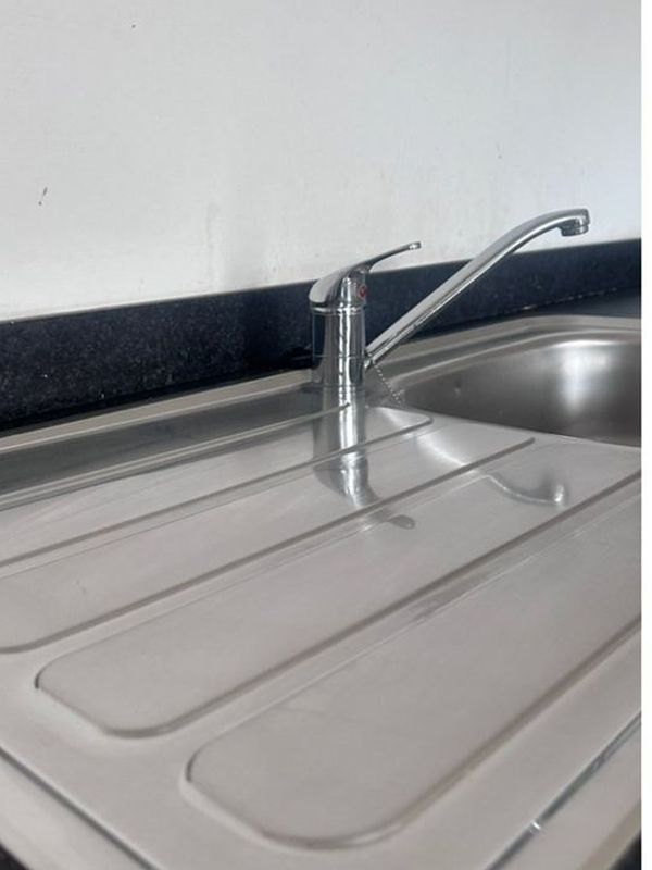 After: the kitchen sink and draining board left gleaming